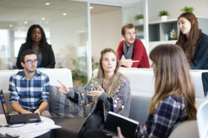 a group of people having a meeting indoors